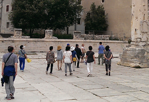 Tourists using a tour guide system outdoors